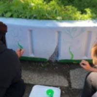 students painting plants on Shawmut Hills sycamore circle mural